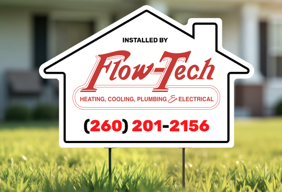 House-shaped Flow-Tech yard sign displayed in a lawn